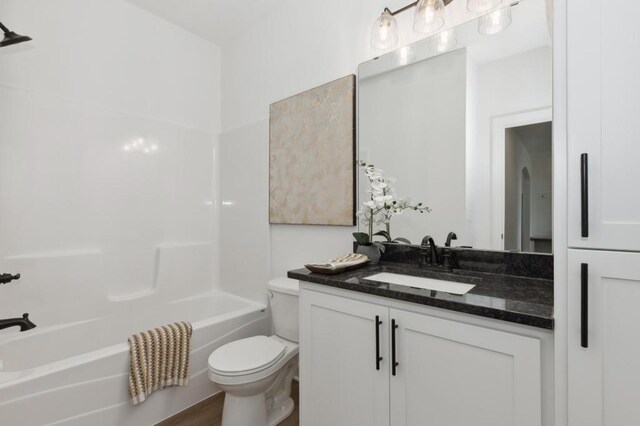 bathroom with vanity, toilet, and washtub / shower combination