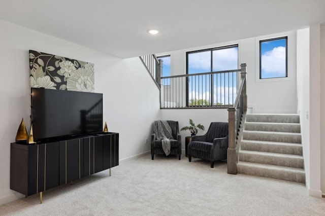 living area with recessed lighting, stairway, baseboards, and carpet