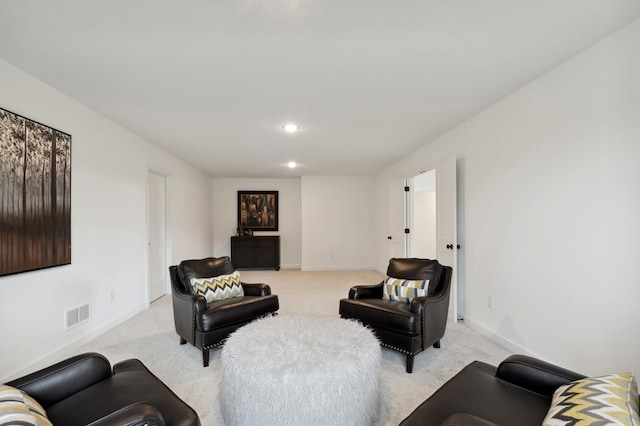 living area with recessed lighting, baseboards, visible vents, and light carpet