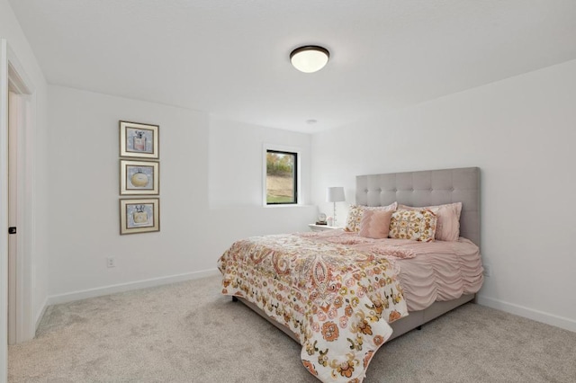 carpeted bedroom featuring baseboards