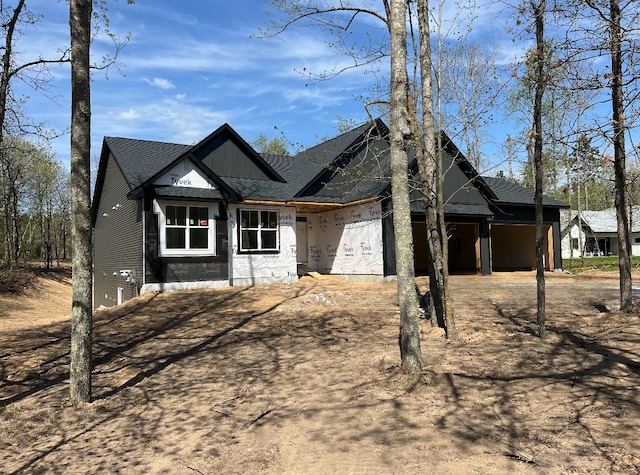 view of front of property with driveway and a shingled roof