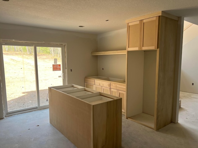 unfurnished office with a textured ceiling and concrete flooring
