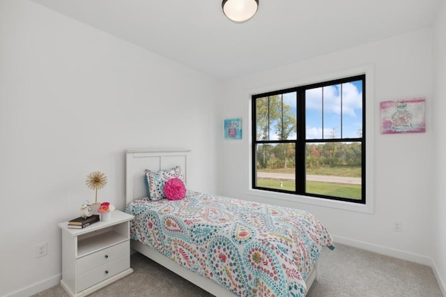 carpeted bedroom featuring baseboards