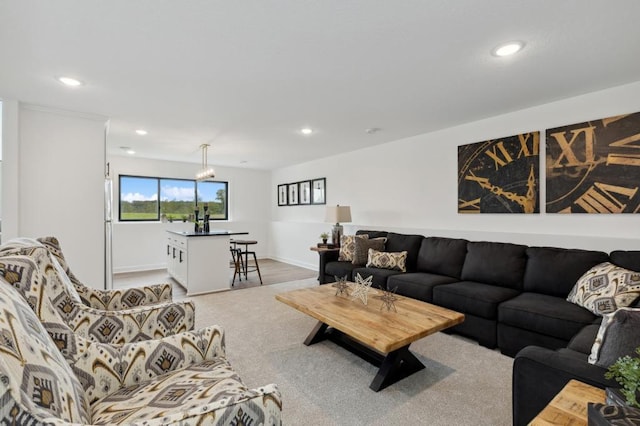 living room featuring recessed lighting, light colored carpet, and baseboards