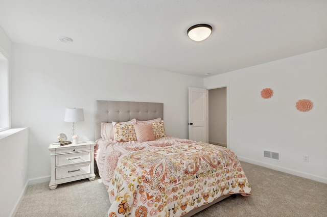 bedroom featuring light colored carpet and baseboards