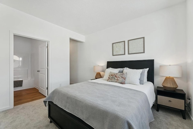 carpeted bedroom featuring visible vents and connected bathroom