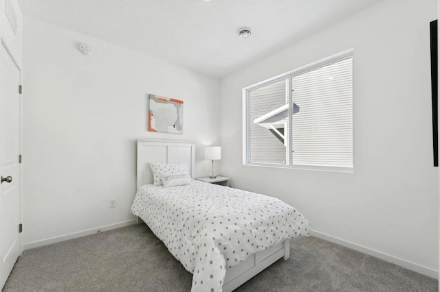 bedroom with baseboards and light colored carpet