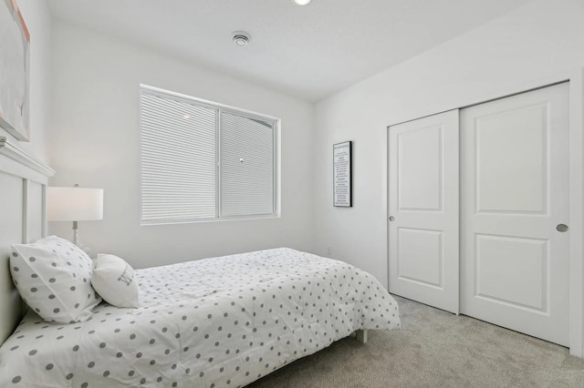 bedroom featuring a closet and light carpet