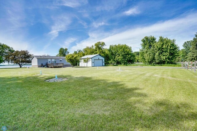 view of yard with a garage and an outdoor structure