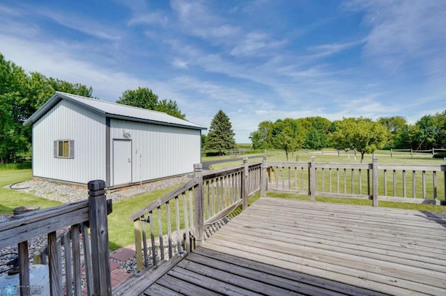 wooden deck with an outbuilding and a yard