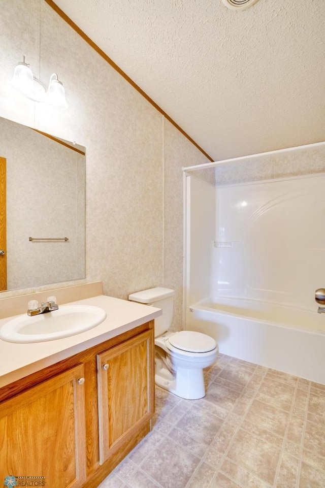 full bathroom with toilet, tub / shower combination, vaulted ceiling, vanity, and a textured ceiling