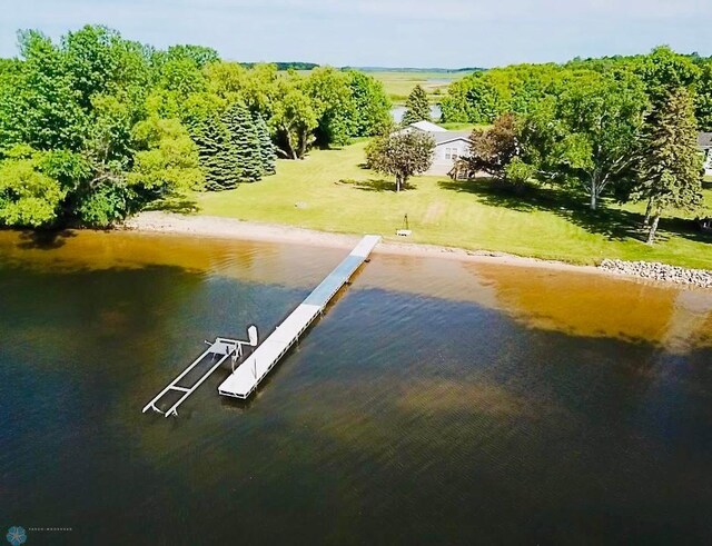 view of dock featuring a yard and a water view