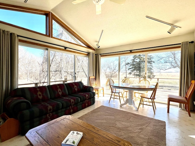 sunroom with track lighting, vaulted ceiling, and a wealth of natural light