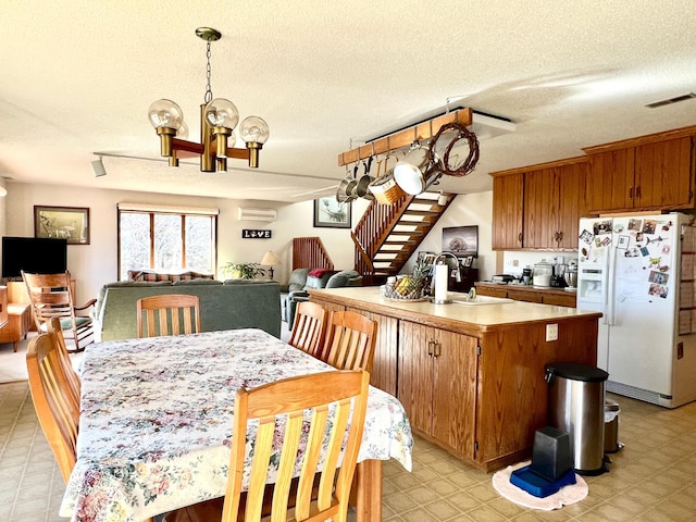 kitchen with light floors, light countertops, visible vents, a sink, and white fridge with ice dispenser