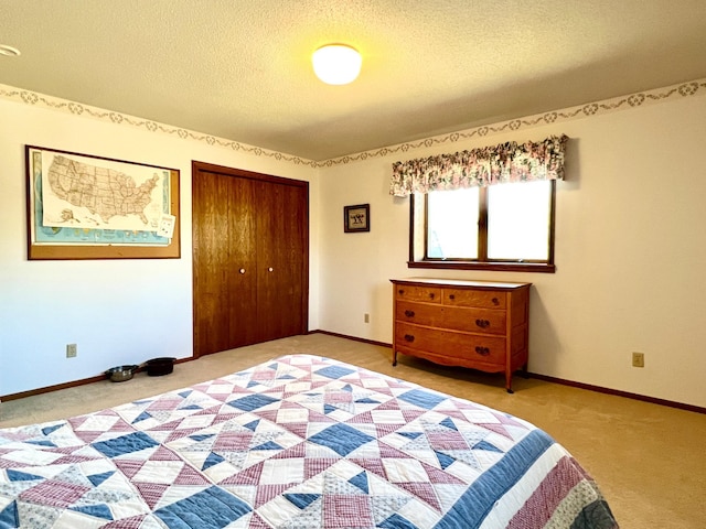 unfurnished bedroom featuring a textured ceiling, baseboards, a closet, and carpet flooring