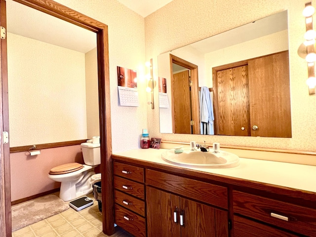 bathroom featuring vanity, toilet, and tile patterned floors