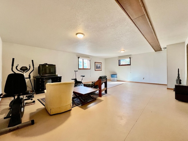 workout area with a textured ceiling and baseboards