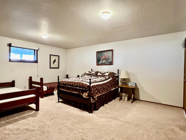 bedroom with a textured ceiling, carpet floors, and baseboards