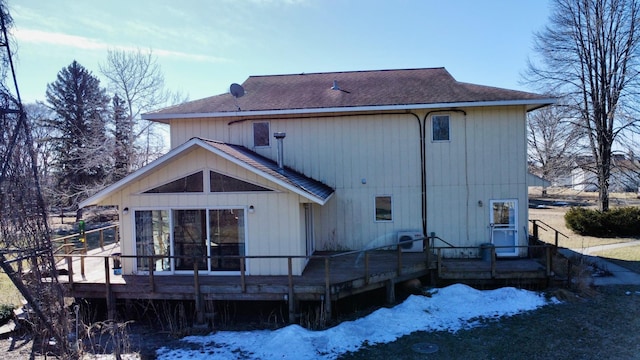 snow covered property with a wooden deck