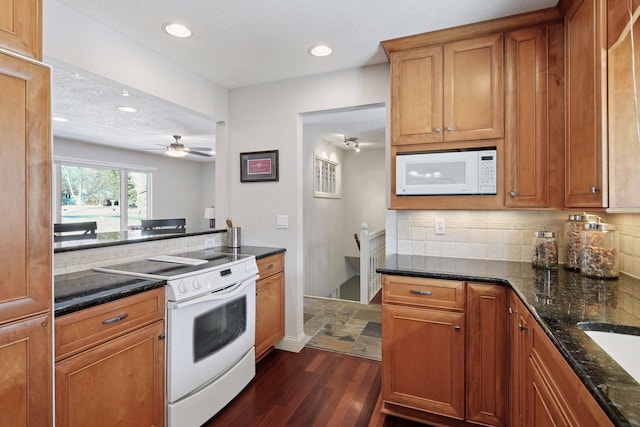 kitchen featuring tasteful backsplash, white appliances, and brown cabinetry