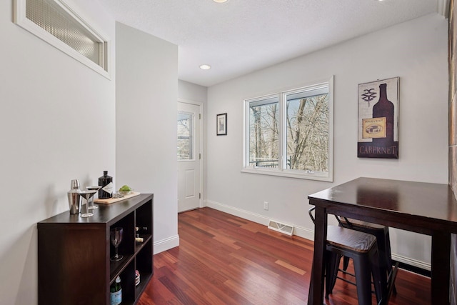 office area with recessed lighting, visible vents, baseboards, and dark wood-type flooring