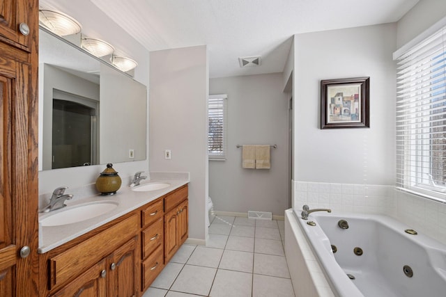 full bath with a sink, visible vents, a jetted tub, and tile patterned floors