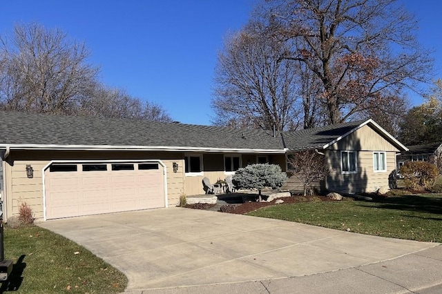 ranch-style house with a front lawn, concrete driveway, a garage, and a shingled roof