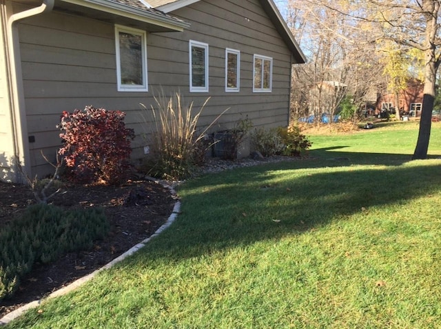 view of side of home featuring a yard