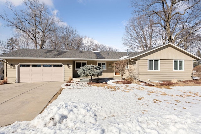 single story home with driveway and an attached garage