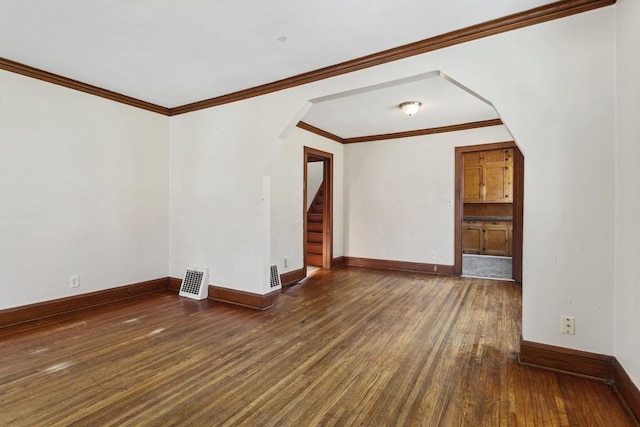 unfurnished living room with stairway, baseboards, arched walkways, and wood-type flooring