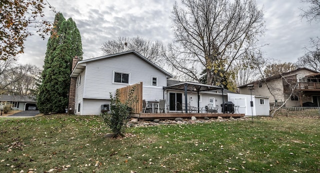 back of property featuring an outdoor structure, fence, a yard, a wooden deck, and a chimney