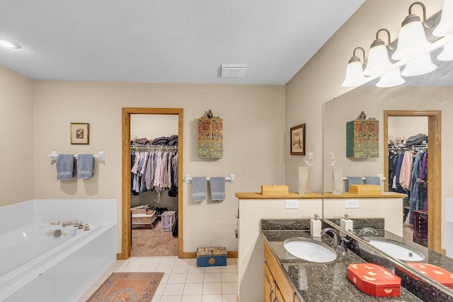 full bathroom featuring a garden tub, tile patterned flooring, a spacious closet, vanity, and a notable chandelier