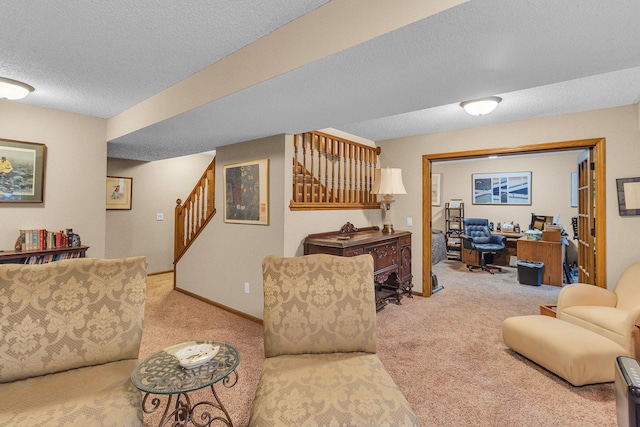 carpeted living area with baseboards, stairway, and a textured ceiling