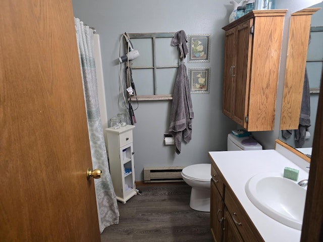 bathroom featuring toilet, a baseboard heating unit, vanity, wood finished floors, and a shower with curtain