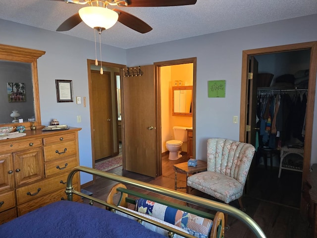 bedroom featuring a textured ceiling, a ceiling fan, a closet, and ensuite bathroom