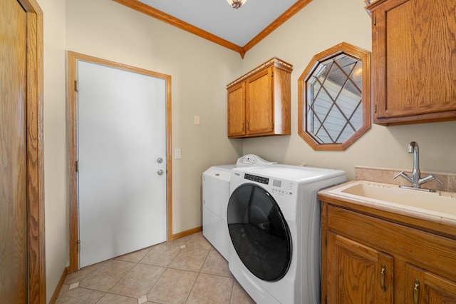 laundry area featuring washing machine and clothes dryer, light tile patterned flooring, cabinet space, a sink, and crown molding