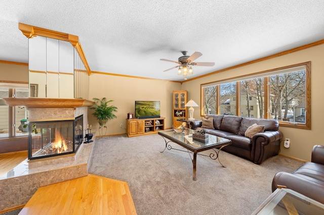 living area featuring a textured ceiling, baseboards, carpet flooring, crown molding, and a multi sided fireplace