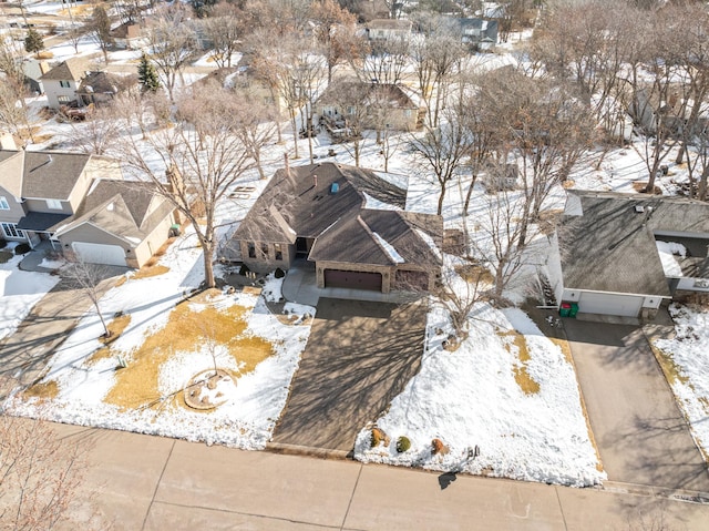 snowy aerial view featuring a residential view