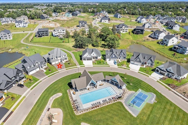 drone / aerial view with a water view and a residential view