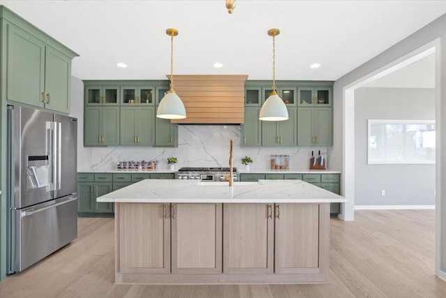 kitchen featuring stainless steel fridge, pendant lighting, tasteful backsplash, and green cabinetry