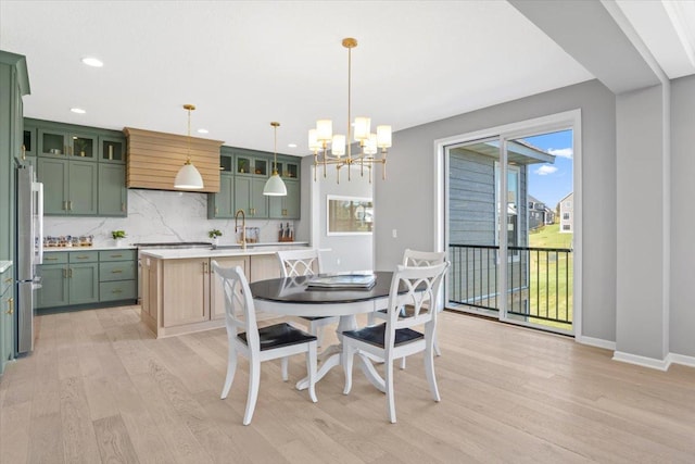 dining area with light wood finished floors, baseboards, a chandelier, and recessed lighting