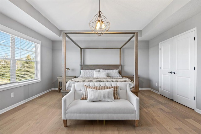 bedroom featuring wood finished floors and baseboards