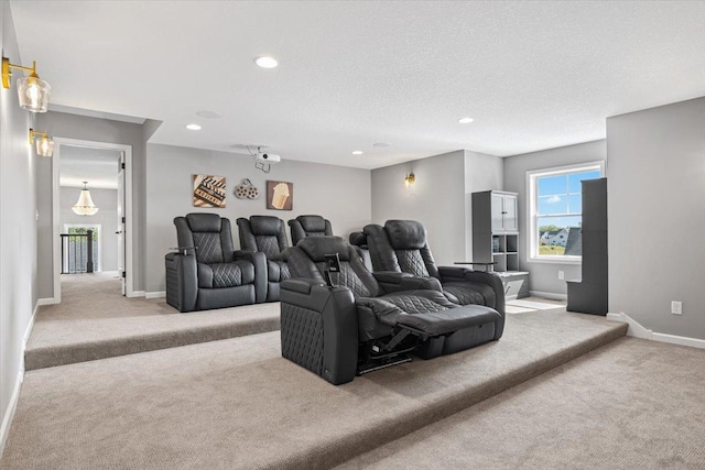 carpeted cinema room featuring a textured ceiling, recessed lighting, and baseboards