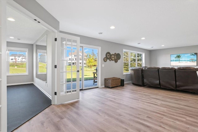 unfurnished living room featuring recessed lighting, baseboards, and wood finished floors