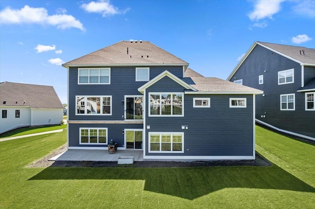 rear view of property featuring a yard and a patio