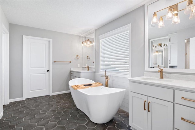 16700 47th Ave N, Plymouth, MN 55446 - full bath with two vanities, a freestanding tub, tile patterned floors, a textured ceiling, and a chandelier