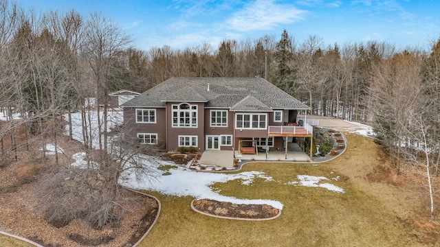 back of property featuring a patio and a wooden deck