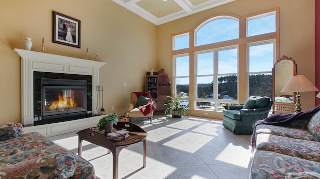 living area featuring a towering ceiling, a fireplace, coffered ceiling, and beamed ceiling