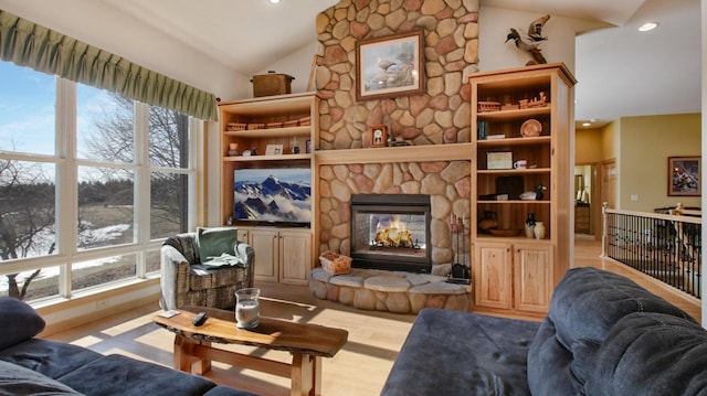 living area featuring high vaulted ceiling, a fireplace, wood finished floors, and recessed lighting