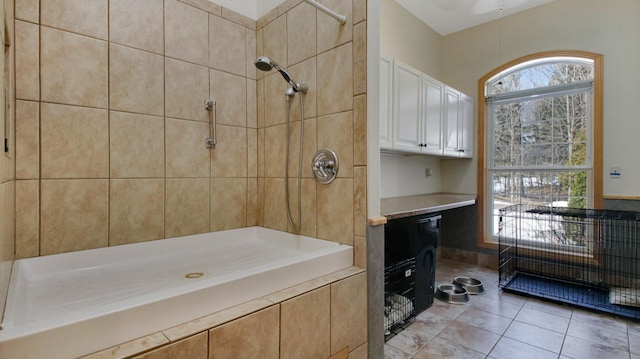 bathroom featuring tiled shower and tile patterned floors